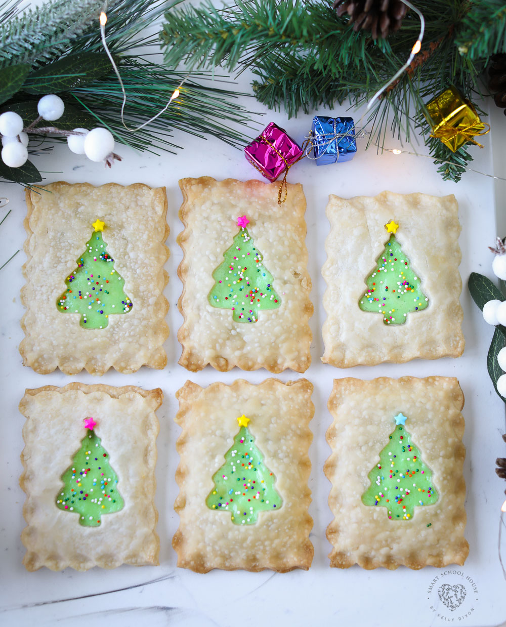 My Christmas Tree Hand Pies are as adorable as it gets! These little handheld pies are filled with delicious cheesecake and surrounded with pie crust and adorned with sprinkles that look like Christmas lights. This holiday dessert idea is sure to get everyone's attention!
