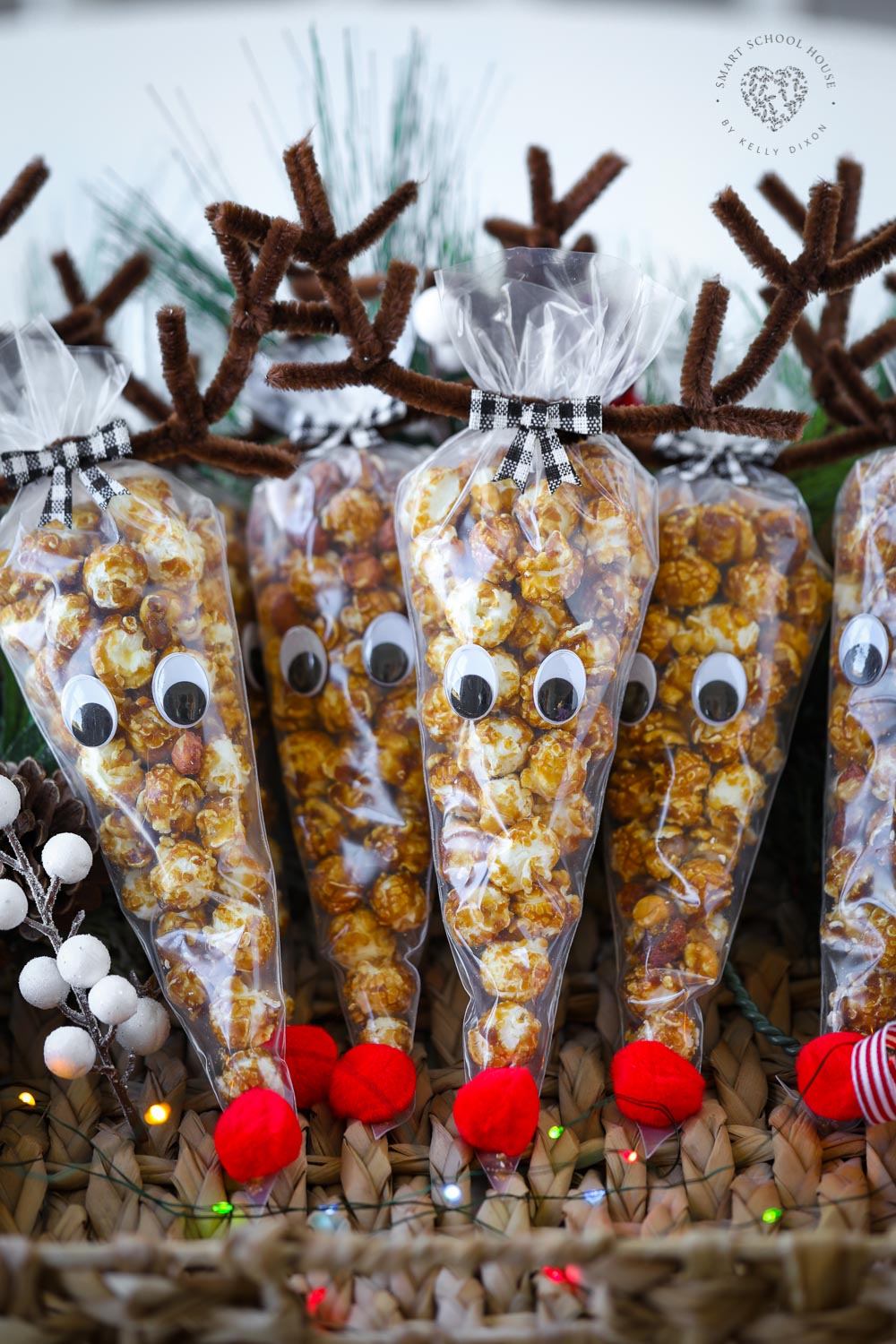 Rudolph is so cute as a Cracker Jack Reindeer! Cone-shaped treat bags filled with caramel corn and topped with pipe cleaner antlers. This is such a cute holiday craft and Christmas gift idea.