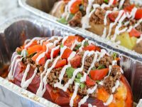 Taco Stuffed Potatoes are nutritious sweet potatoes OR everyone's favorite russet potatoes overflowing with seasoned meat and classic taco toppings!