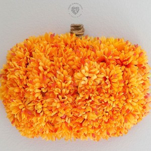 Make this pretty Floral Pumpkin Wreath using supplies from the dollar store! This handmade wreath is so easy to make, anyone can do it!