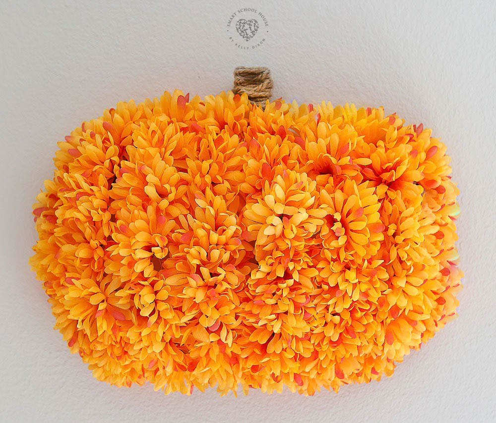 Make this pretty Floral Pumpkin Wreath using supplies from the dollar store! This handmade wreath is so easy to make, anyone can do it!
