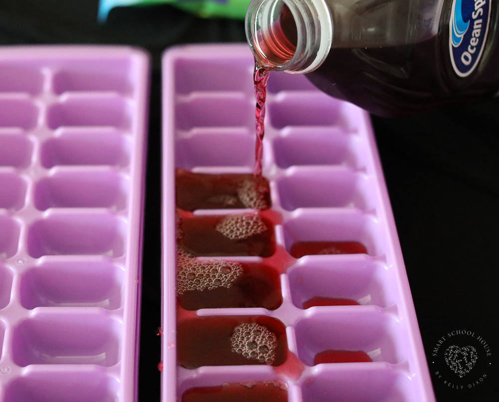 pouring juice in ice cube tray