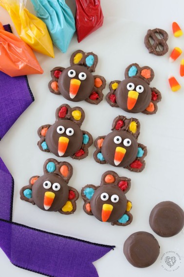 Chocolate Covered Pretzel Turkeys with colorful turkey feathers and a candy corn beak! A fun and festive treat for Thanksgiving!