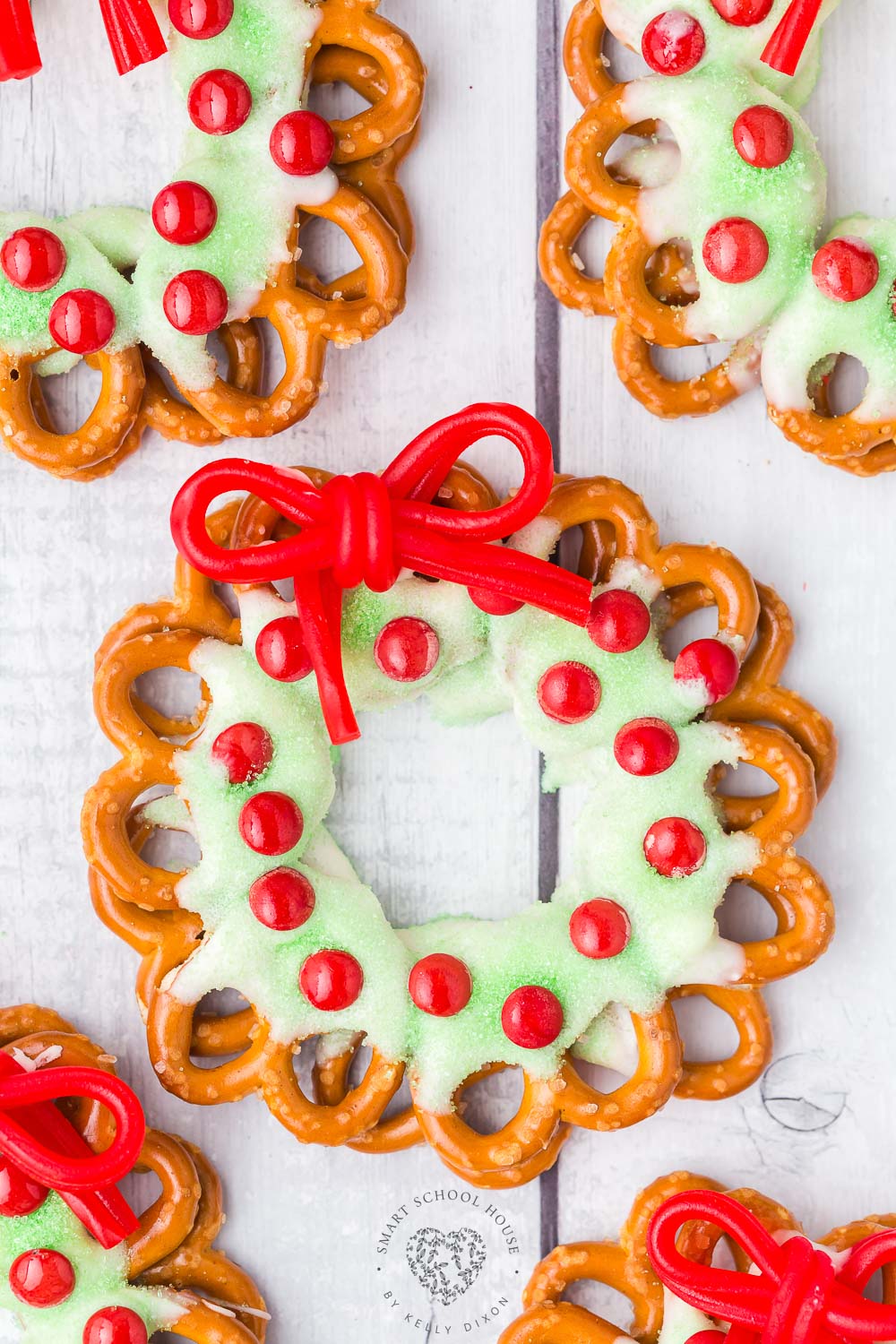 Pretzel Wreaths with a red licorice bow are an adorable and festive Christmas food craft idea! A favorite holiday treat.