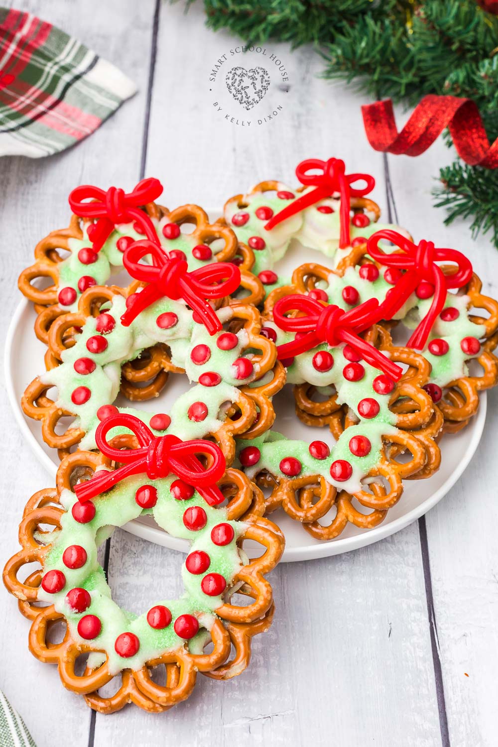 Pretzel Wreaths with a red licorice bow are an adorable and festive Christmas food craft idea! A favorite holiday treat.
