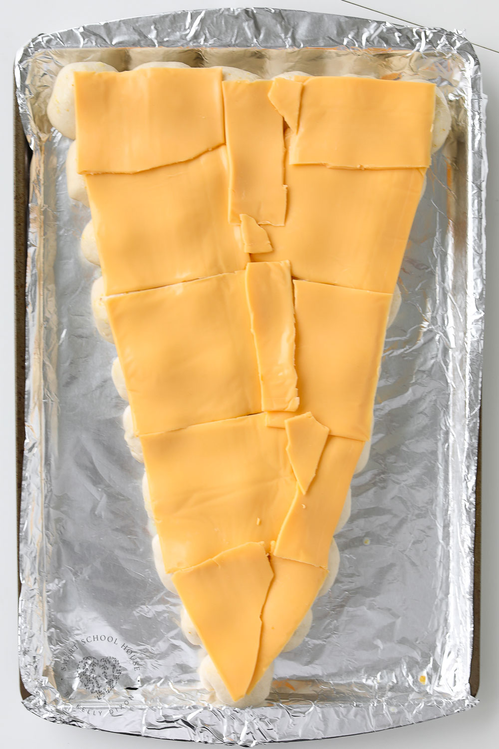 Carrot shaped bread covered in American cheese