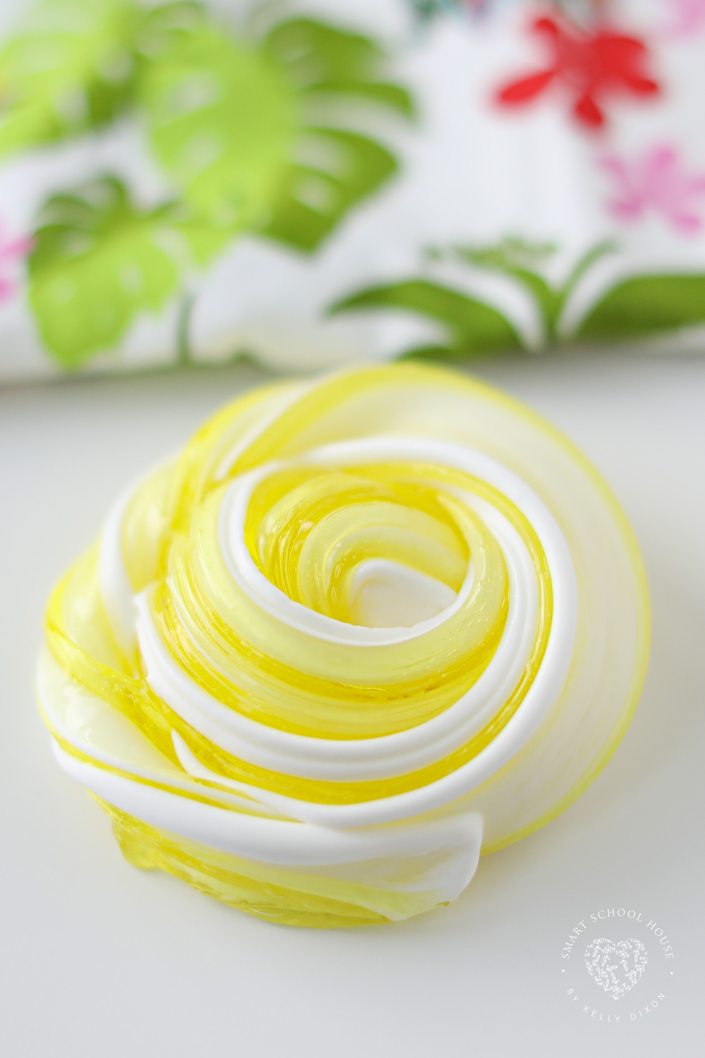 Make Dole Whip Slime for a Hawaiian sensory activity! It has a thick and clear yellow base with a white fluffy topping.