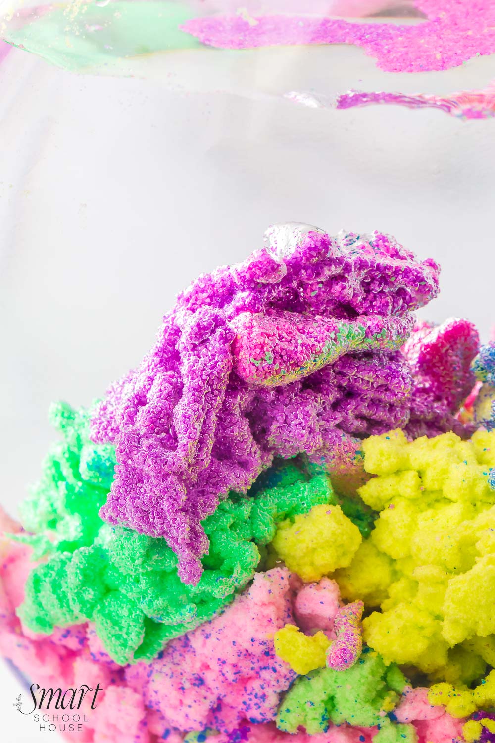 How to make Magic Sand that stays dry in the water! Also known as Aqua Sand, this fun and colorful waterproof sand is poured into water, creating a coral-like appearance that can be used over and over again!