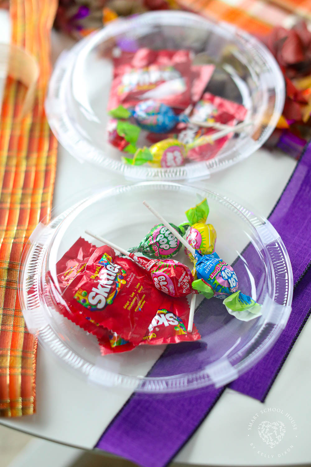 Candy taped inside 2 clear plates