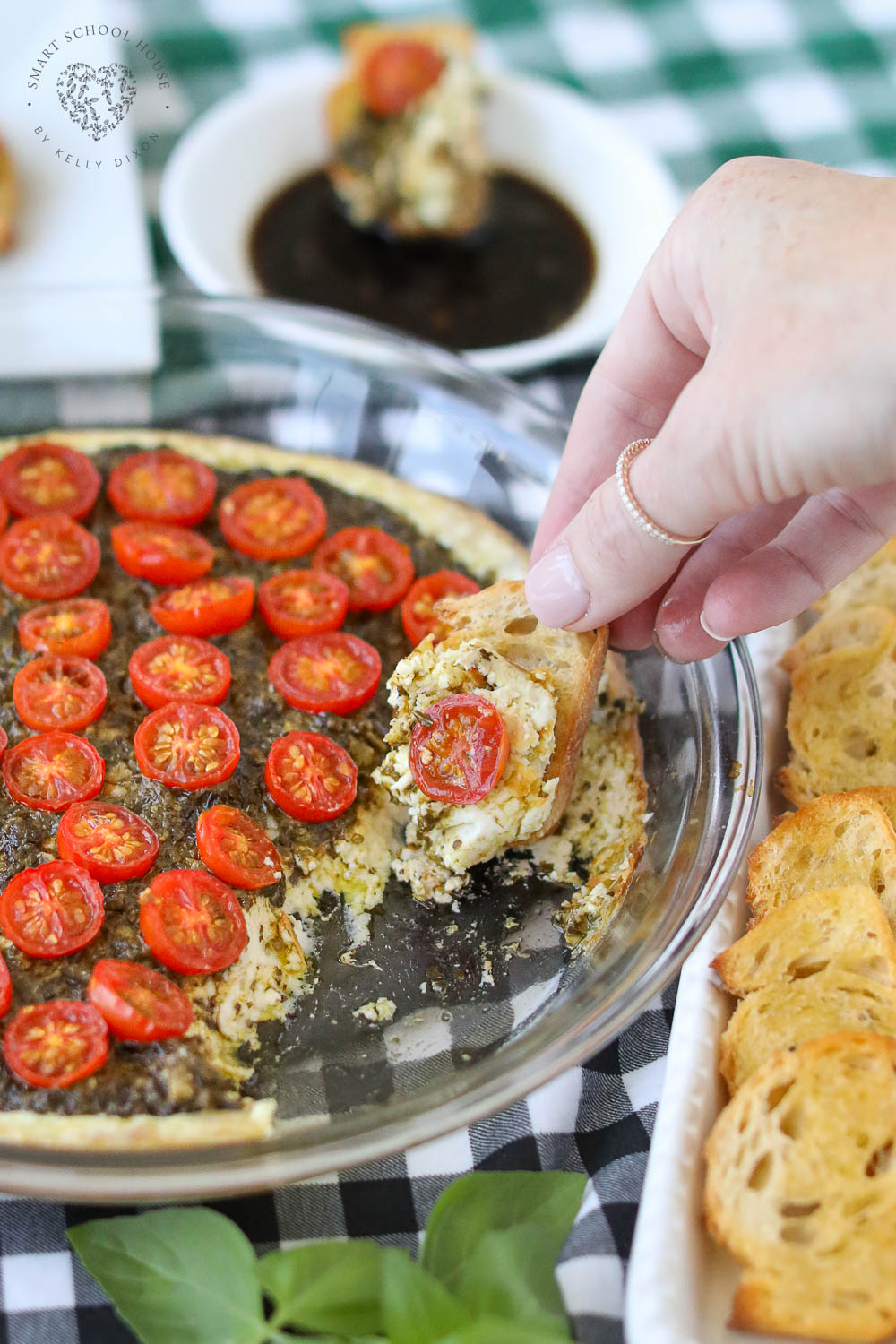 Warm Caprese Dip features ooey gooey cheese melted with pesto and topped with cherry tomatoes. An excellent appetizer idea for the holidays, game day, or any get-together! 