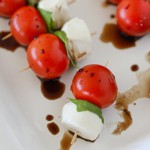 Caprese Salad Skewers are a beautiful and easy appetizer idea! Sweet cherry tomatoes on top of basil and a cute little ball of mozzarella.