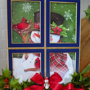 A dollar store Framed Christmas Gift Bag is a creative DIY holiday decoration! You can use any gift bag and picture frames you like!