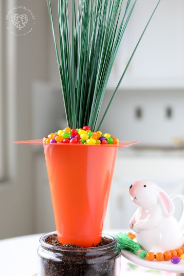 Use an orange traffic cone to make a Giant Carrot Centerpiece for the Easter table! This dollar store centerpiece is filled with Jelly Beans!