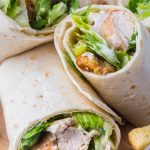 These Chicken Caesar Salad Wraps are a satisfying grab-and-go meal loaded with fresh ingredients, protein-packed chicken, and creamy Caesar dressing—all wrapped up in a soft tortilla.