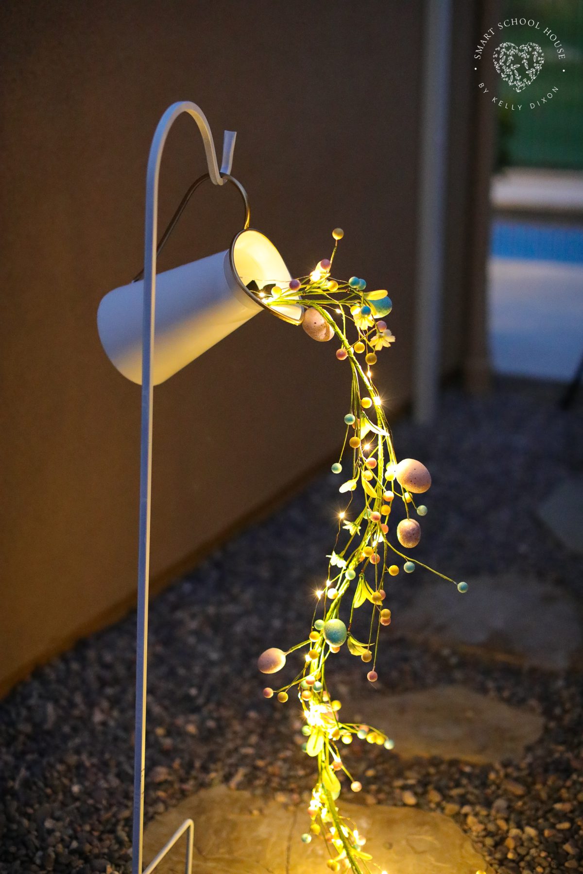 Create a magical spring display with this Pouring Easter Garland craft. A unique DIY Easter craft for adults using fairy lights, Easter egg garland, and simple supplies.